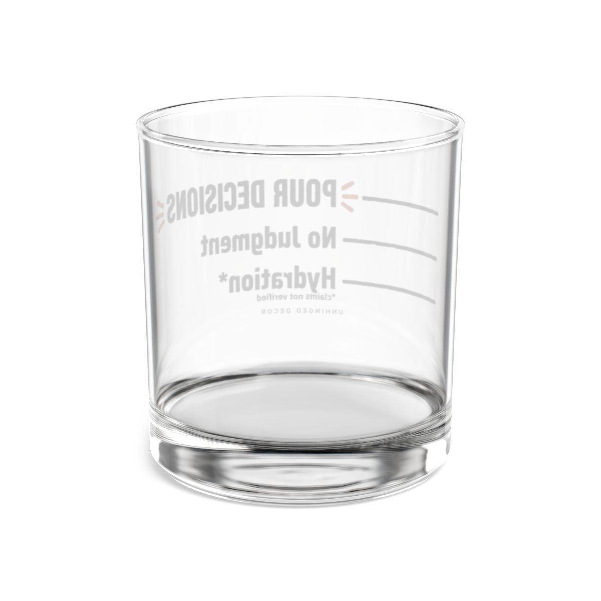 Back view through the clear Pour Decision rocks glass, pour lines Hydration* → No Judgment → POUR DECISIONS reversed, Unhinged Decor.